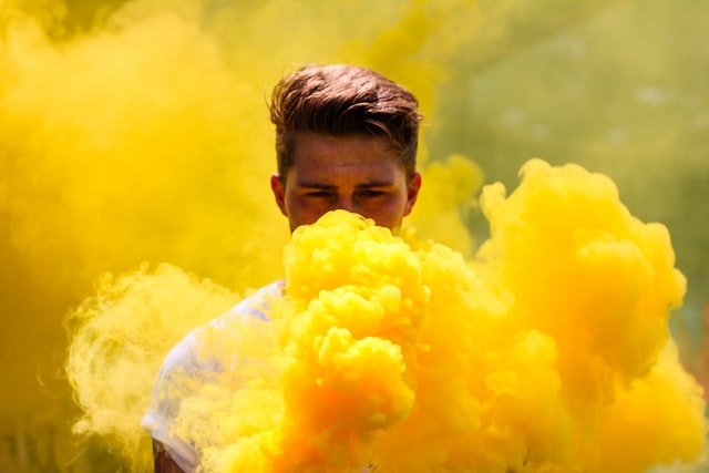 Person standing in yellow smoke